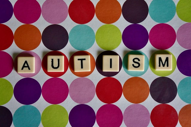 The word Autism on a colorful background of circles