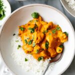 Butter chicken with rice in a bowl.
