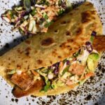 Vegan Fish Tacos with Spicy Sesame Slaw on a Speckled Plate