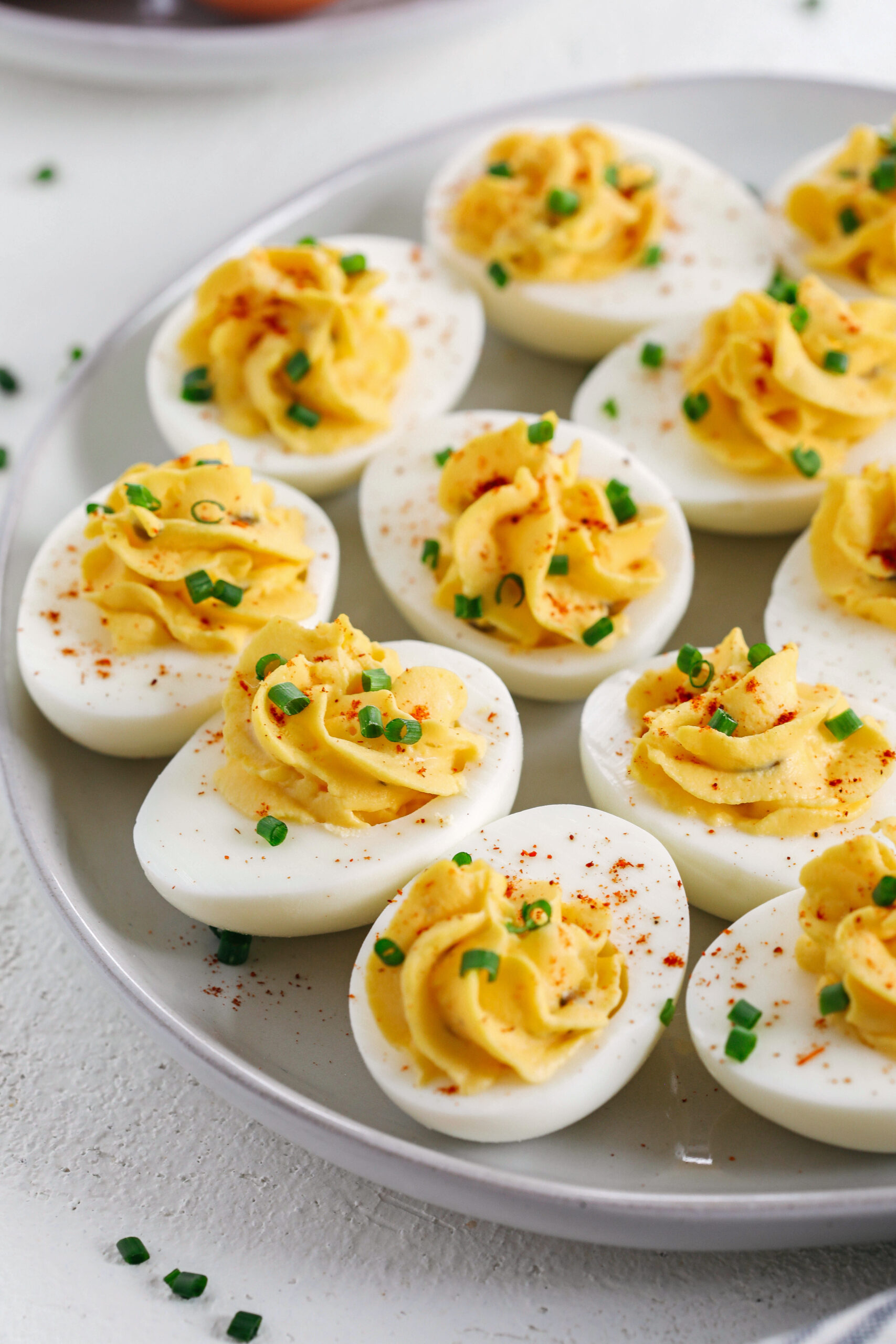 These Healthier Deviled Eggs are a classic recipe that are much lighter in calories thanks to using Greek yogurt!  Perfect for parties, Sunday brunch or even a delicious afternoon snack! 