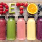 Assorted flavoured smoothie juices in bottles with detox spelt using fruits and vegetables