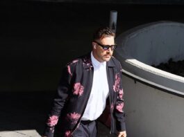 Travis Kelce strolled into SoFi Stadium in a black and pink bomber jacket and dark shades