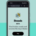 NYT Strands homescreen on a mobile phone screen, on a light blue background
