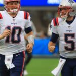 New England Patriots quarterbacks Mac Jones and Brian Hoyer running on to the field before they play the Los Angeles Chargers during NFL action at SoFi Stadium. (Matthew J Lee/Globe staff)