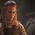 Annatar standing with his chin resting on his right hand as he ponders something in The Rings of Power season 2