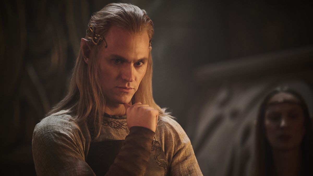 Annatar standing with his chin resting on his right hand as he ponders something in The Rings of Power season 2