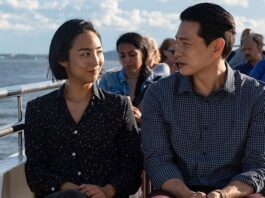 Two people sit on a ferry