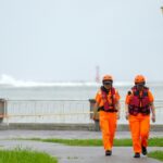 Waves break off Sizihwan Bay beauty spot in Kaohsiung as coast guard officers patrol ahead of the arrival of Super Typhoon Krathon (WALID BERRAZEG)